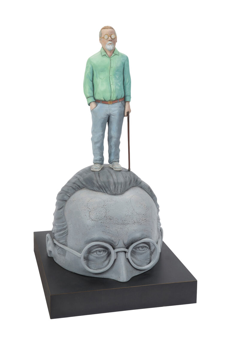 sculpture of a man standing on a large head