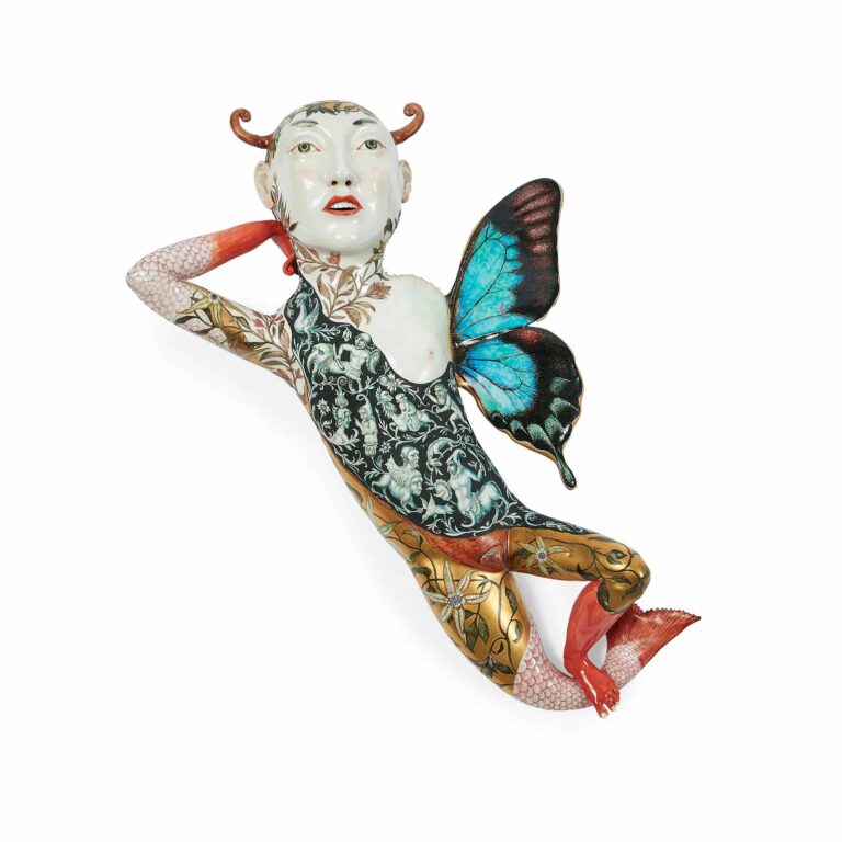 sculpture of a person combined with a butterfly and a fish