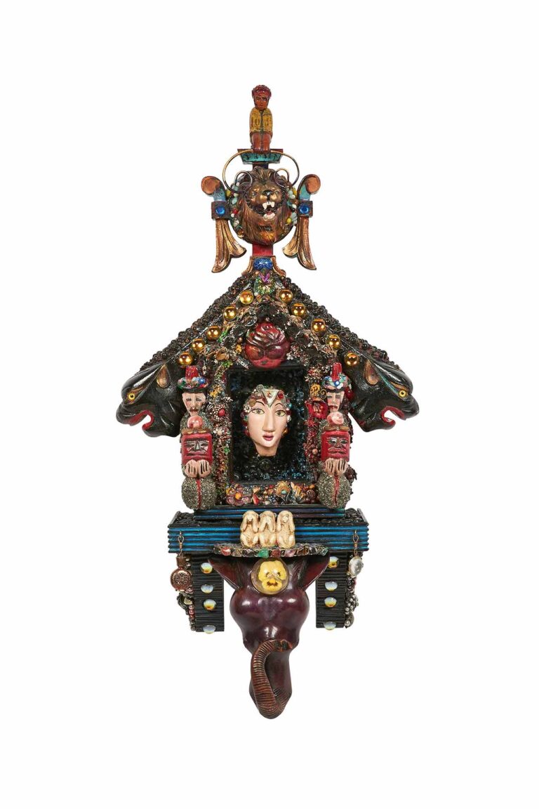 a sculpture that resembles a bird house with figures and gems