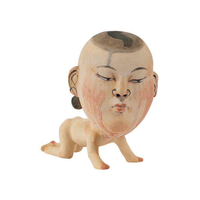 A sculpture of a baby with a large head.