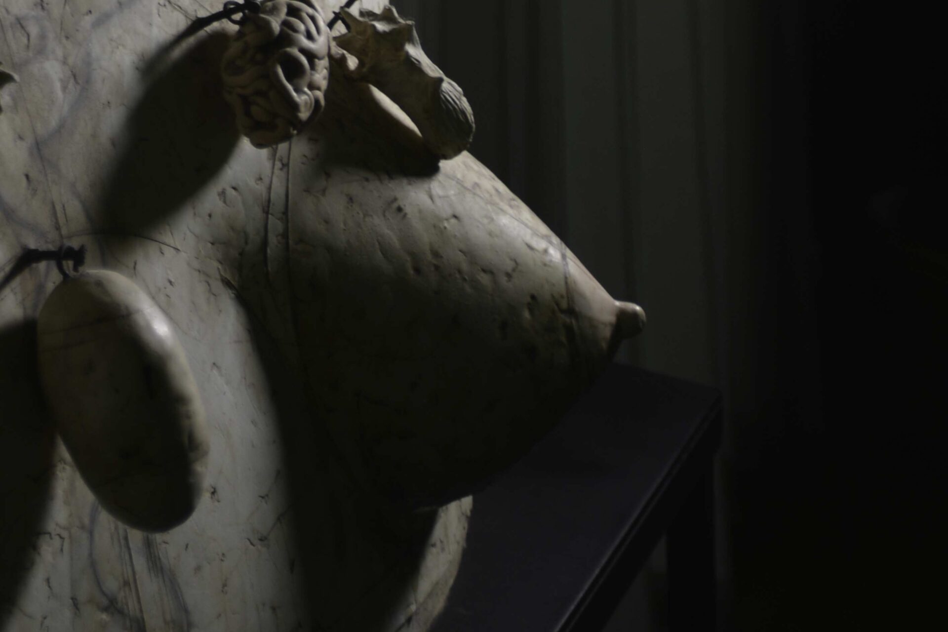 A close-up shot of a three-headed dimensional sculpture.