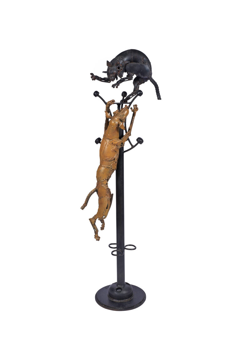 A sculpture of a coat and hat rack with a dog and cat.