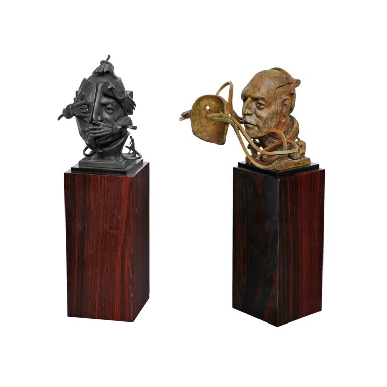 Two abstract bronze sculptures of heads.