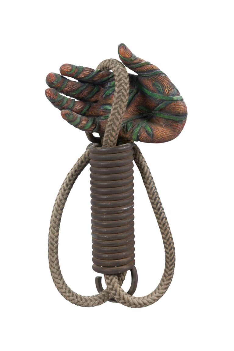 A sculpture of a hand holding a rope.