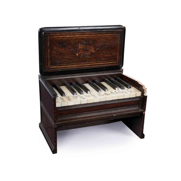 A wood engraved miniature piano.