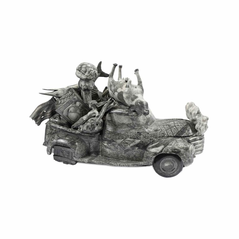 A sculpture of a car with various garbage on it.