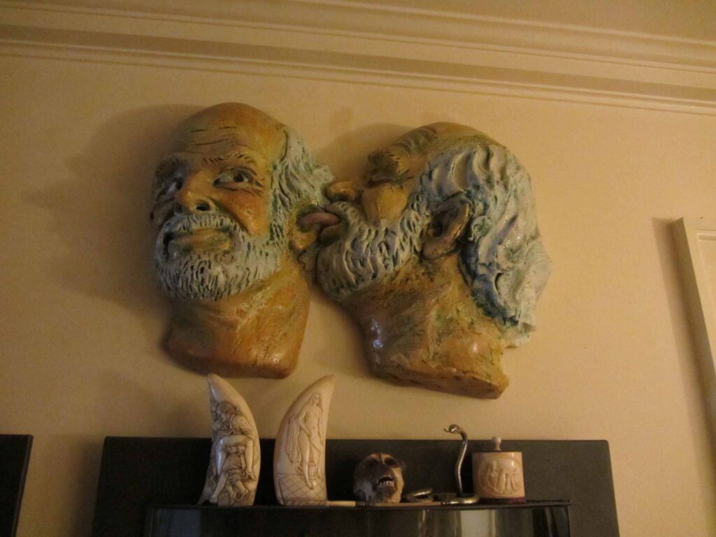 Two 3D self-portraits of Arneson licking the inside of his own ear.