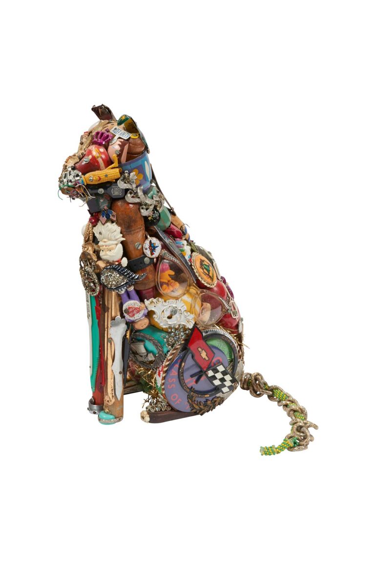 A sculpture of a cat made out of various items.