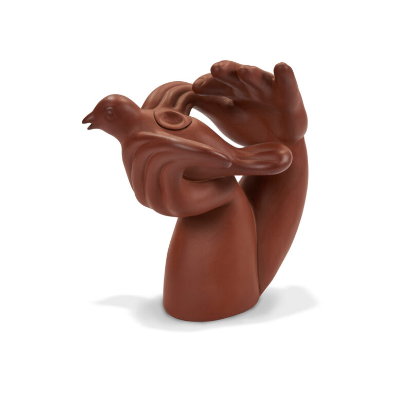 A ceramic sculpture of a bird in hand.