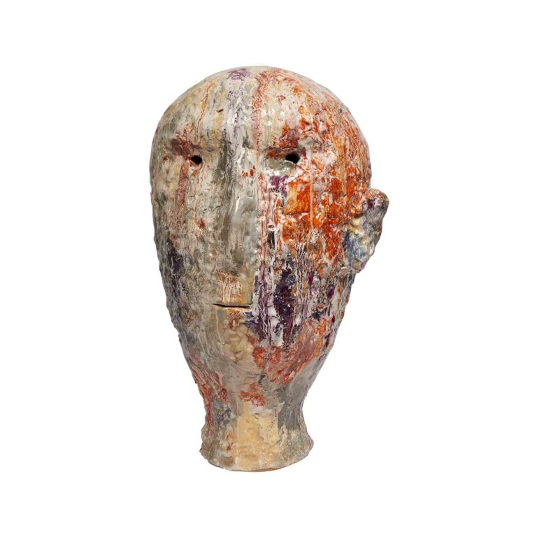A ceramic sculpture of a figures head.